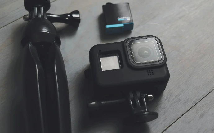 A couple of cameras sitting on top of a wooden floor